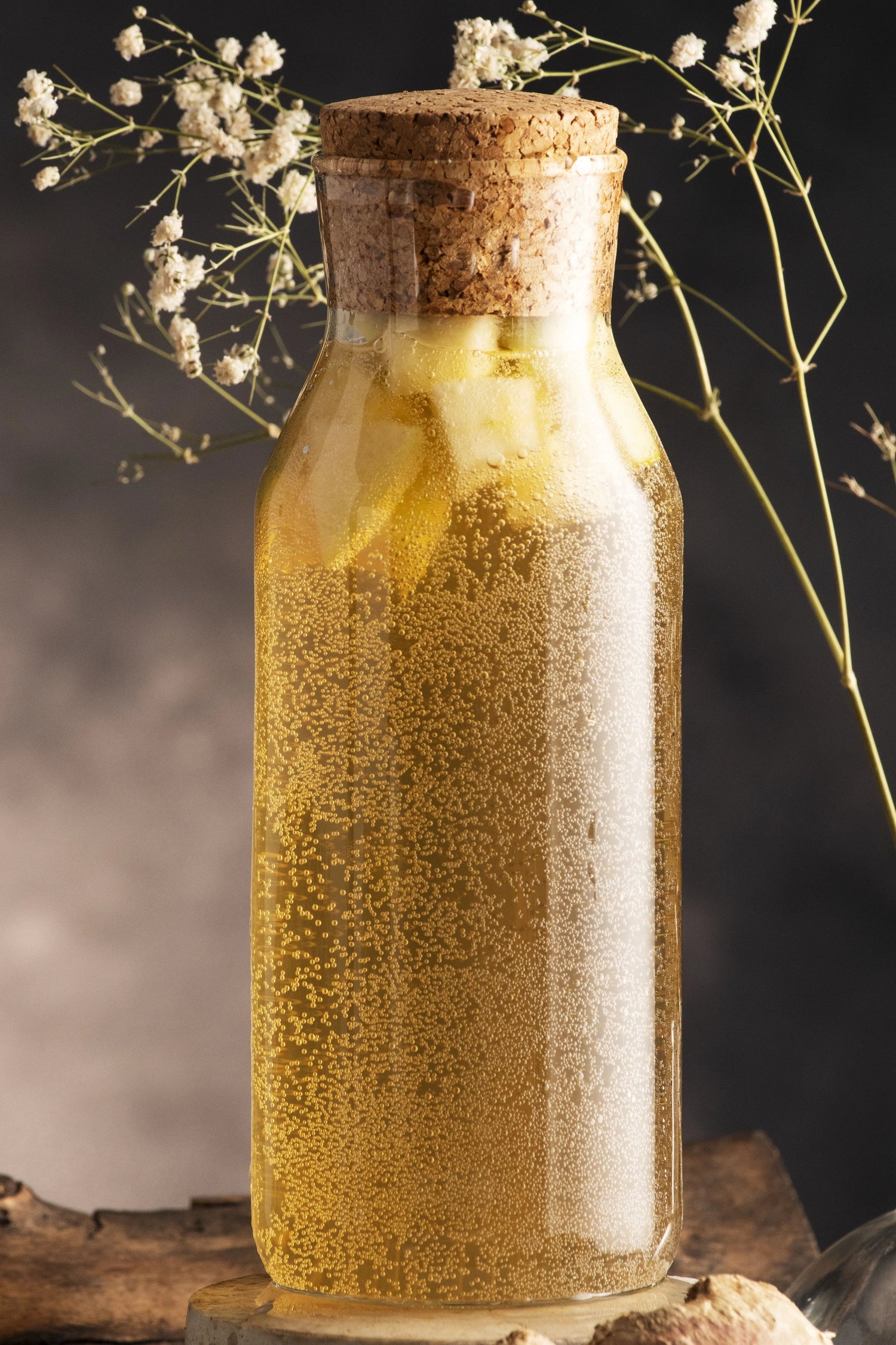 Bottle of fenugreek oil with natural seeds on a wooden surface, used as a natural hair growth oil to strengthen and thicken hair