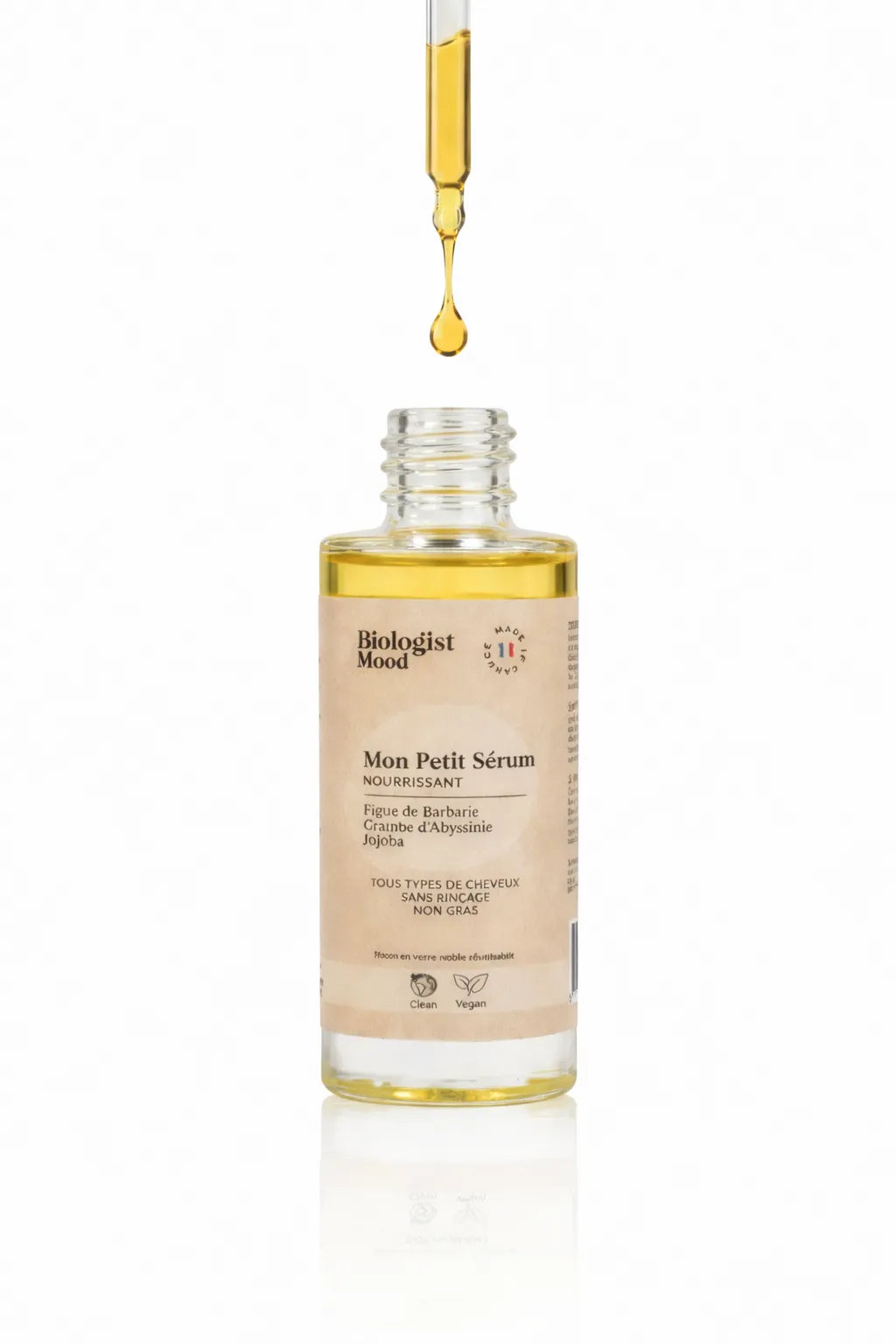sérum cheveux Biologist Mood avec pipette déposant une huile nourrissante pour hydrater et réparer les cheveux secs